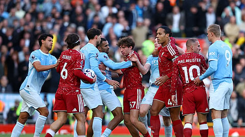 Manchester City's Iliman Ndiaye clashes with Liverpool's Lewis Koumas.