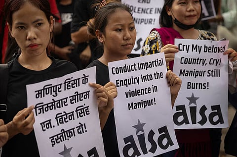 Protestors hold placards as they attend a protest against the alleged sexual assault of two tribal women in the eastern state of Manipur, in New Delhi, India, July 21, 2023