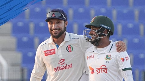 Afghanistan skipper Rahmat Shah and Bangladesh batter Mehidy Hasan Miraz at the end of the third day's play of the one-off Test at the Zayed Cricket Stadium in Abu Dhabi, UAE on Sunday.