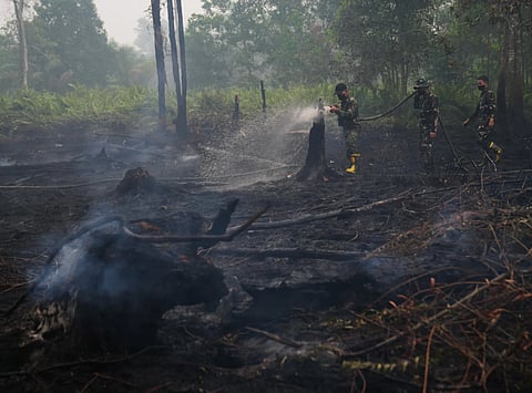 Soldiers put out wildfires in Indonesia in September, 2026.