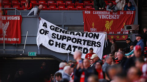 Liverpool fans with a banner related to the Manchester City's Premier League charges inside the stadium before the match.