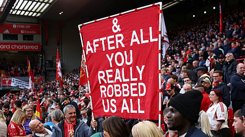 Liverpool fans with a banner related to the Manchester City's Premier League charges inside the stadium before the match.