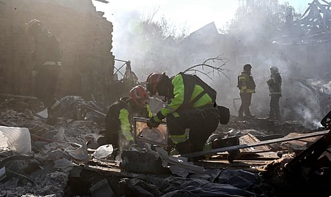 Rescuers work on destroyed private houses following a deadly Russian guided aerial bomb attack at the weekend.
