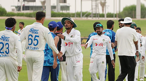 Bangladesh and Afghanistan players shake hands after the one-off Test ended in a draw in Abu Dhabi.