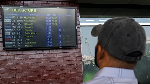 A migrant worker is checking the flight schedule. (File Photo)