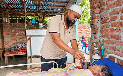 Sazedul Islam Saju is taking care of an abandoned elderly in his home