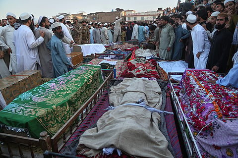 Mourners attend funeral prayers of children, who died in a roof collapse of a private school, in Peshawar, Pakistan, Thursday, Oct 15, 2026. 