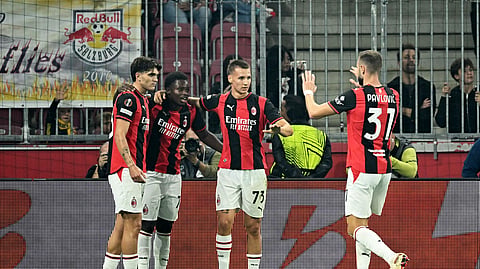 AC Milan's Alphadjo Cisse celebrates scoring their first goal with teammates.
