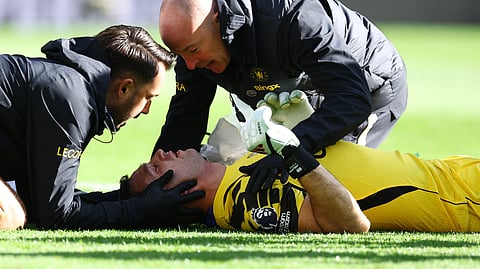 Chelsea's Emiliano Martinez receives medical attention after sustaining an injury.