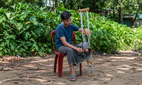 Mohammad Hanif sits beside his crutches in Teknaf after losing a leg in a landmine explosion near the Bangladesh-Myanmar border while out fishing with his nephew