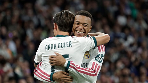 Real Madrid's Kylian Mbappe embraces teammate Arda Guler during their UEFA Champions League match against RB Leipzig on Wednesday.