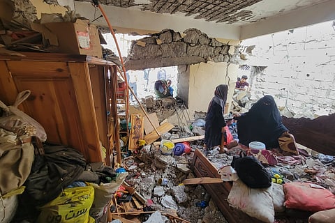 Residents walk on their home debris at Seina district in Taiz, Yemen, after a missile strike, Tuesday, Oct 20, 2026.