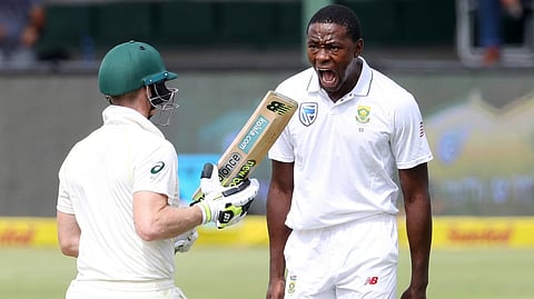 South Africa pacer Kagiso Rabada (R) celebrates the wicket of Australia's Steve Smith.