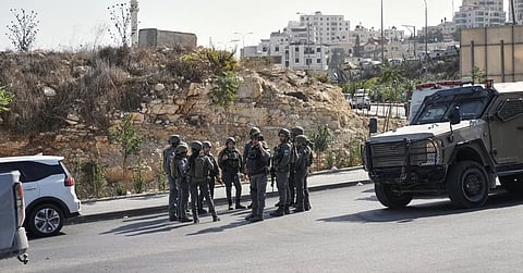 Israeli soldiers gather at the scene of a shooting attack carried out by Palestinian gunmen at a junction near Hebron in the occupied West Bank on Friday, Oct 23, 2026.