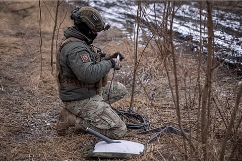 A Ukrainian serviceman of 47th brigade prepares a Starlink satellite internet systems at his positions at a front line, amid Russia's attack on Ukraine, near the town of Avdiivka, recently captured by Russian troops in Donetsk region, Ukraine February 20, 2024. 