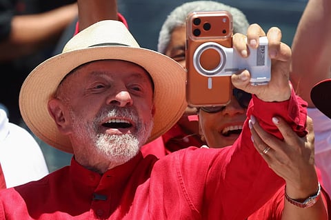 Brazilian President Luiz Inacio Lula da Silva, candidate for reelection for the Workers' Party (PT), uses his wife Rosangela "Janja" da Silva's phone at a campaign rally, ahead of the presidential runoff, in Natal, Brazil, October 10, 2026. 