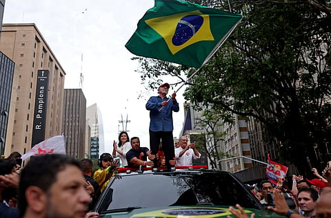 Brazilian President Luiz Inacio Lula da Silva, the Workers' Party (PT) candidate seeking re-election, waves a flag during a closing campaign rally ahead of the presidential runoff, in Sao Paulo, Brazil, October 24, 2026. 
