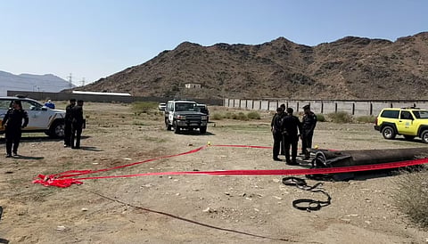 Officials inspect debris from ballistic missile interceptions, in Ar Rashidiyyah, near Mecca, Saudi Arabia, in this image released on October 24, 2026. 