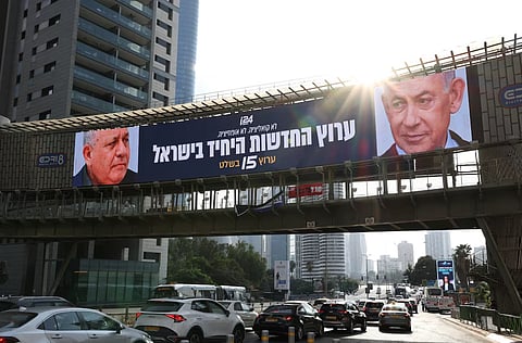 An advert for an Israeli television channel that will broadcast Israel's election coverage features Israeli Prime Minister Benjamin Netanyahu and former Israeli military chief Gadi Eisenkot, leader of the Yashar party, ahead of Israel's national election, on a bridge in Tel Aviv, Israel, October 21, 2026