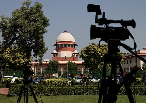 Members of media speak in front of cameras outside the premises of the Supreme Court in New Delhi, India October 13, 2022.