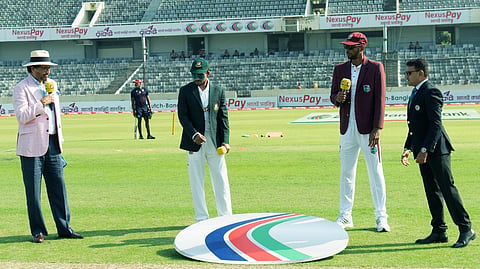 Bangladesh captain Najmul Hossain Shanto and his West Indian counterpart Roston Chase at the toss ahead of the first Test at the Sher-e-Bangla National Cricket Stadium in Dhaka on Wednesday.