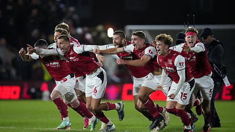 Fleetwood Town's Rhys Bennett and teammates celebrate winning the penalty shootout.