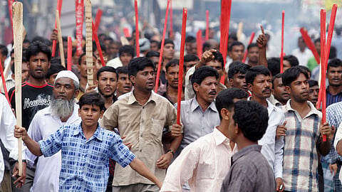 Supporters of the opposition Awami League march with sticks on the street during a protest in Dhaka October 28, 2006.