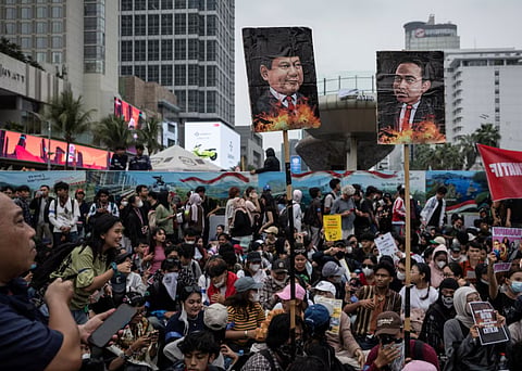 Activists hold pictures depicting Indonesian President Prabowo Subianto and vice President Gibran Rakabuming Raka, during a protest against their policies, and as their government's handling of forest fires, at the Hotel Indonesia roundabout in Jakarta, Indonesia, October 28, 2026.