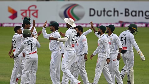 Taijul Islam (L) celebrates with his Bangladesh teammates after taking a wicket on day two of the first Test against West Indies.