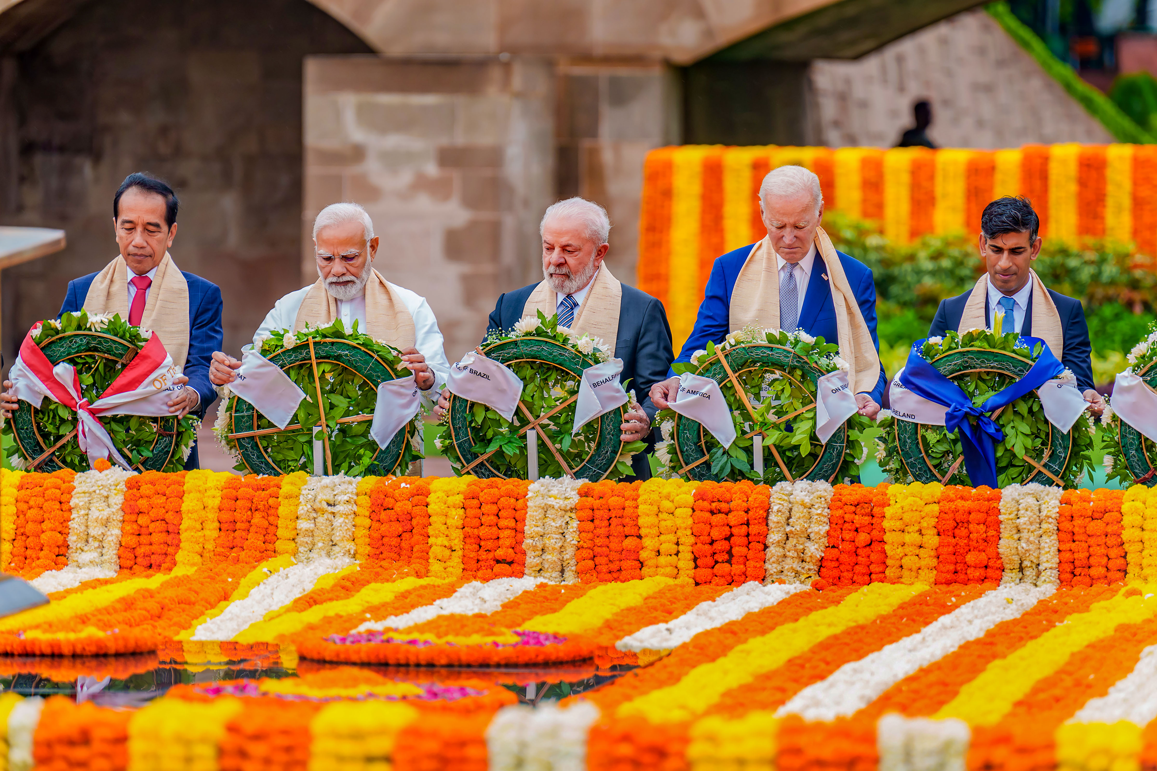 Prime Minister Narendra Modi, US President Joe Biden, Brazil's President Luiz Inacio Lula da Silva, United Kingdom's Prime Minister Rishi Sunak and Indonesian President Joko Widodo pay homage at Mahatma Gandhi's memorial Rajghat on the final day of the G20 Summit, in New Delhi, Sunday, Sept. 10, 2023. 