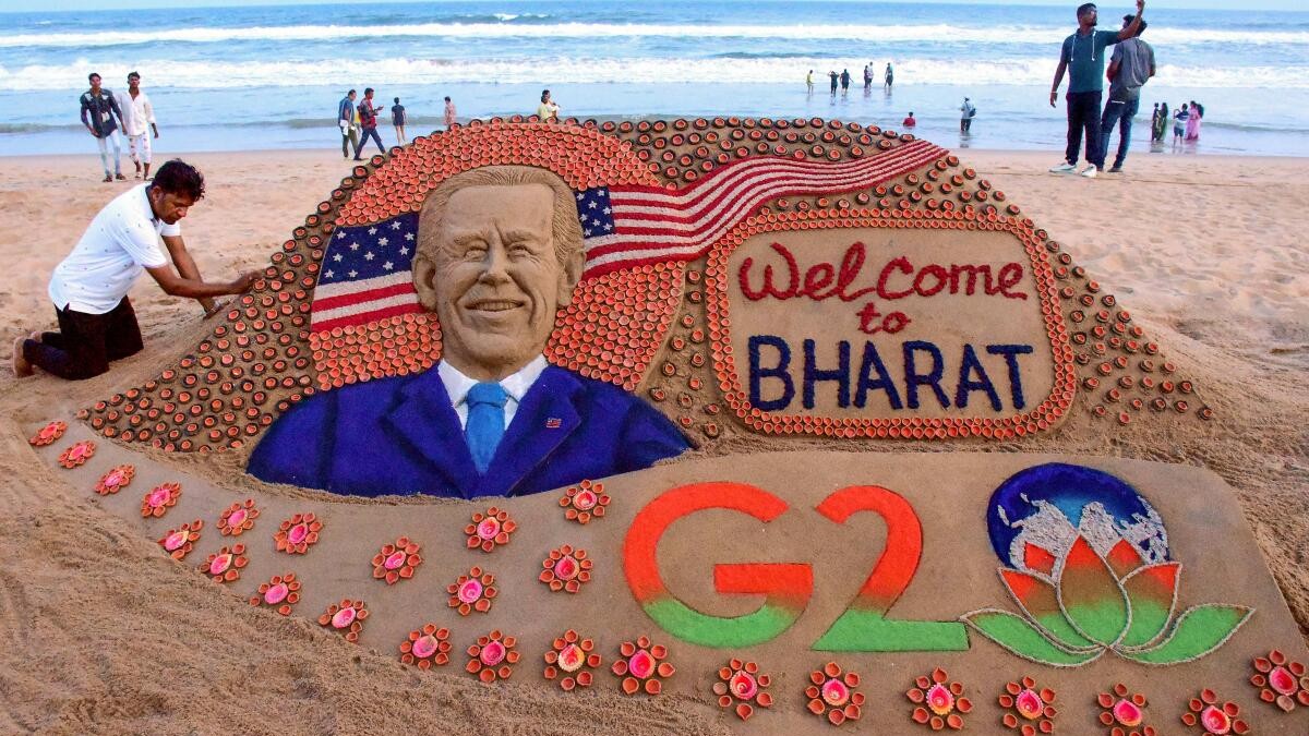 Sand artist Sudarsan Pattnaik creates a sand sculpture by installing around 2000 'diyas' to welcome US President Joe Biden for G20 Summit, at Puri beach, Odisha.