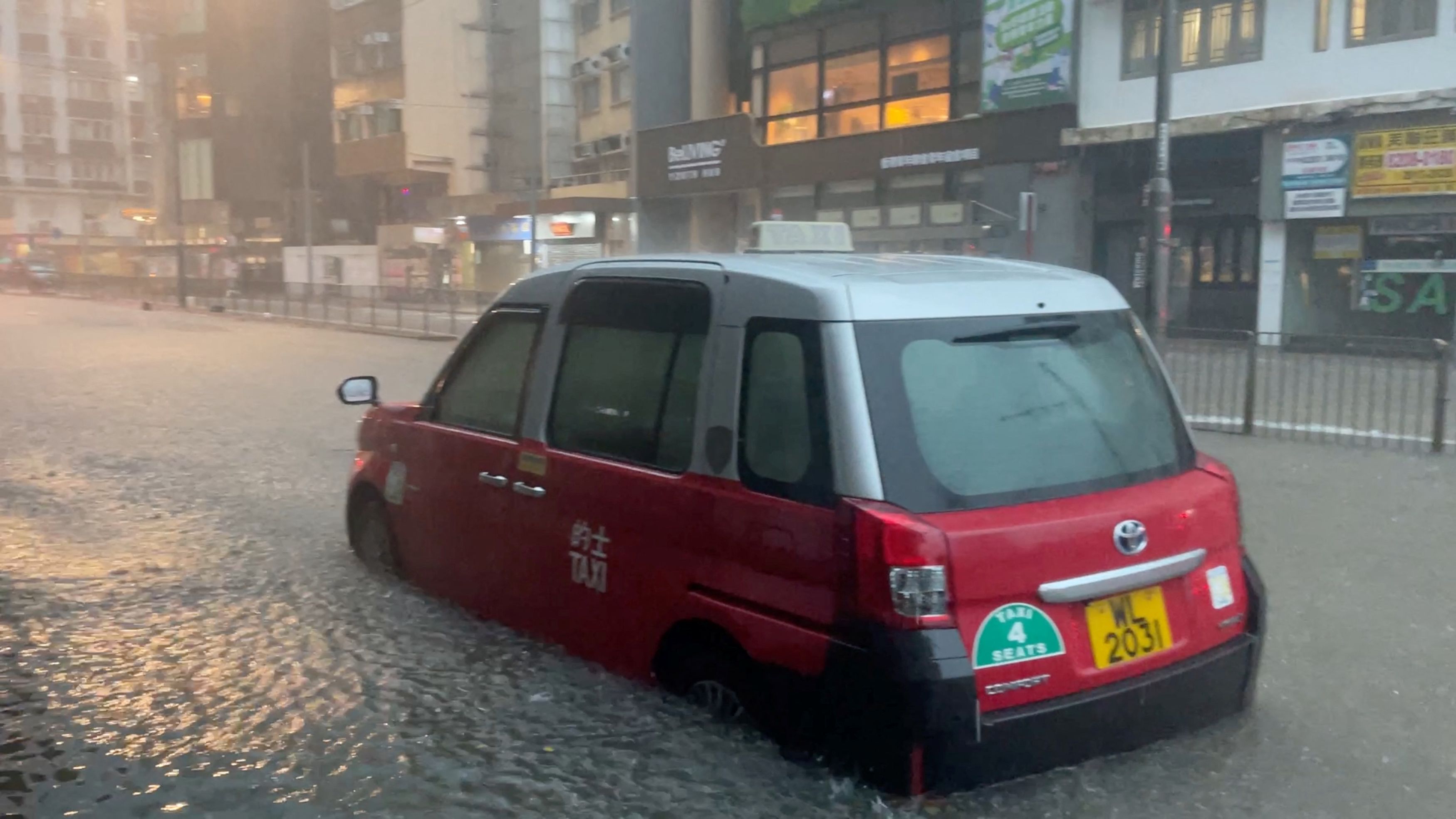 A partially submerged vehicle is surrounded by floodwaters amid torrential rain in Hong Kong, China.
