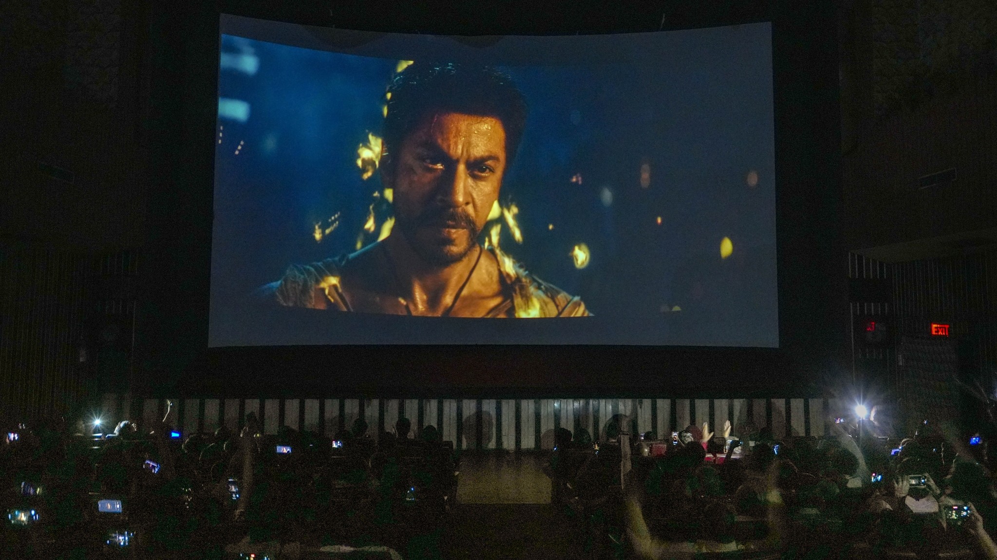 Fans cheer inside a cinema hall while watching his latest film "Jawan" at 6am, in Mumbai, Thursday, Sept. 7, 2023.