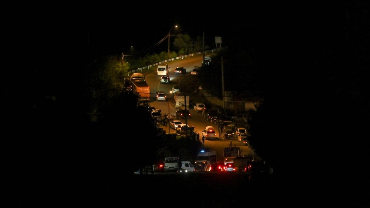 Residents drive vehicles as they leave the city of Stepanakert following a military operation conducted by Azerbaijani armed forces in Nagorno-Karabakh, a region inhabited by ethnic Armenians. 
