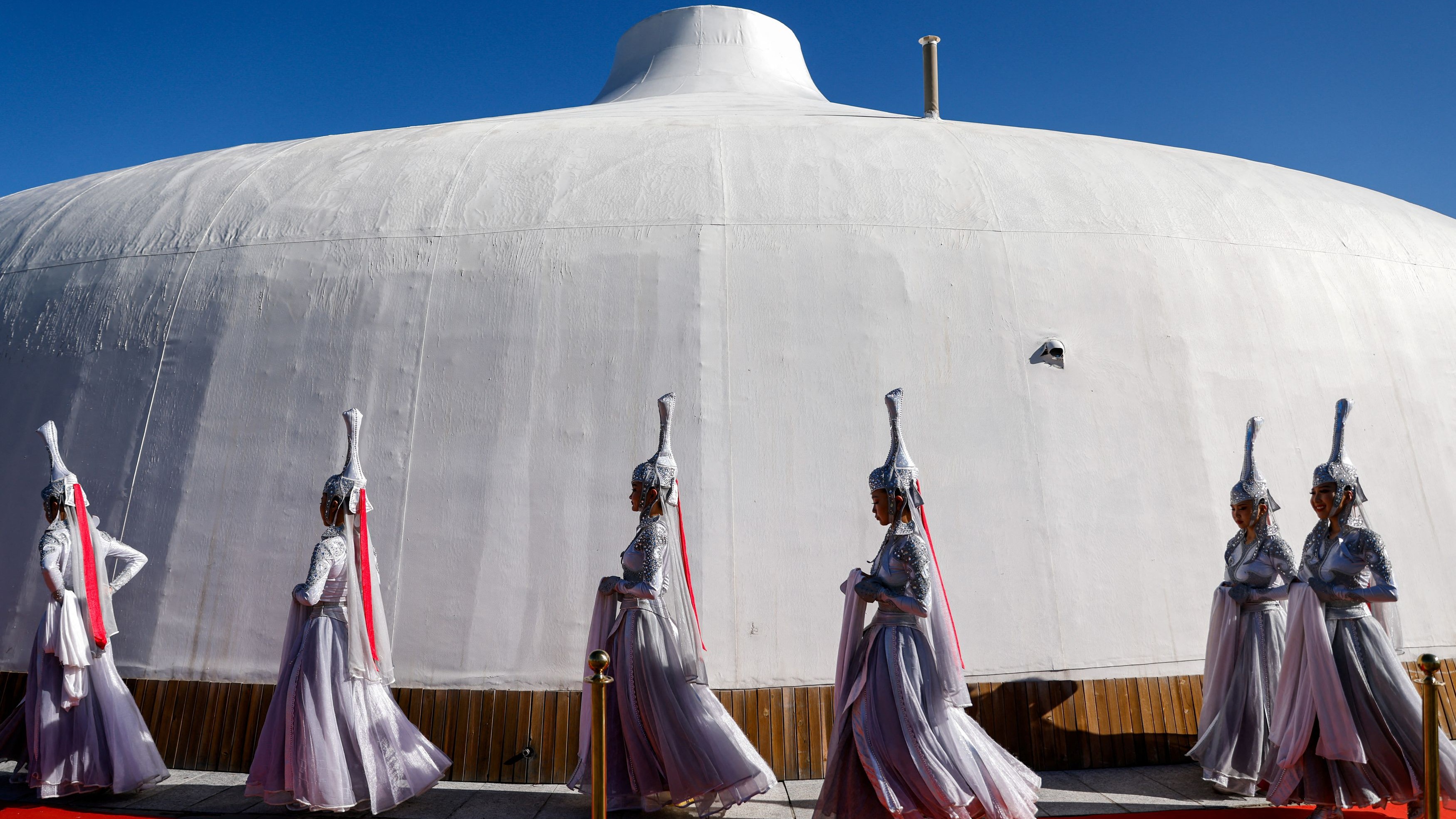 Women in traditional attire walk outside the venue ahead of an ecumenical and interreligious meeting at the Hun Theatre, during Pope Francis' Apostolic Journey in Ulaanbaatar, Mongolia September 3, 2023.