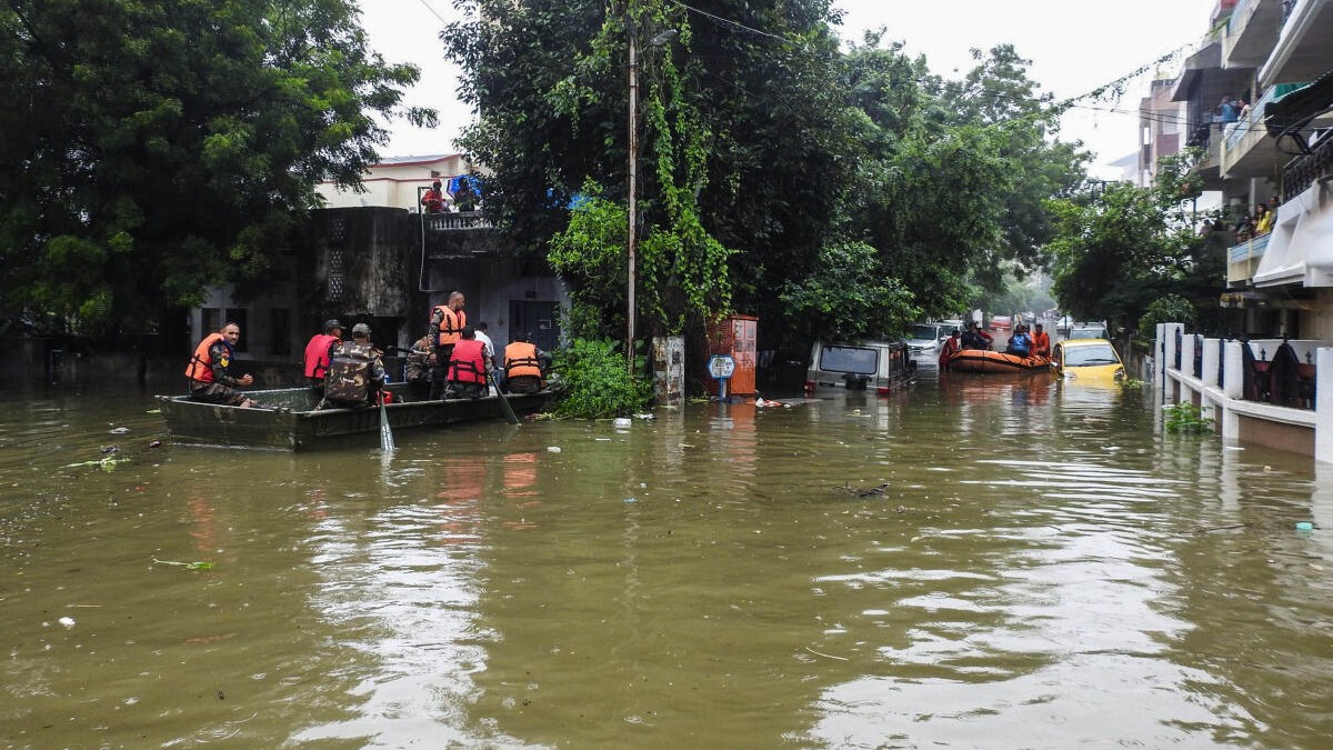 Indian Army personnel rescue people stranded in a flooded area after heavy rain, in Nagpur. 