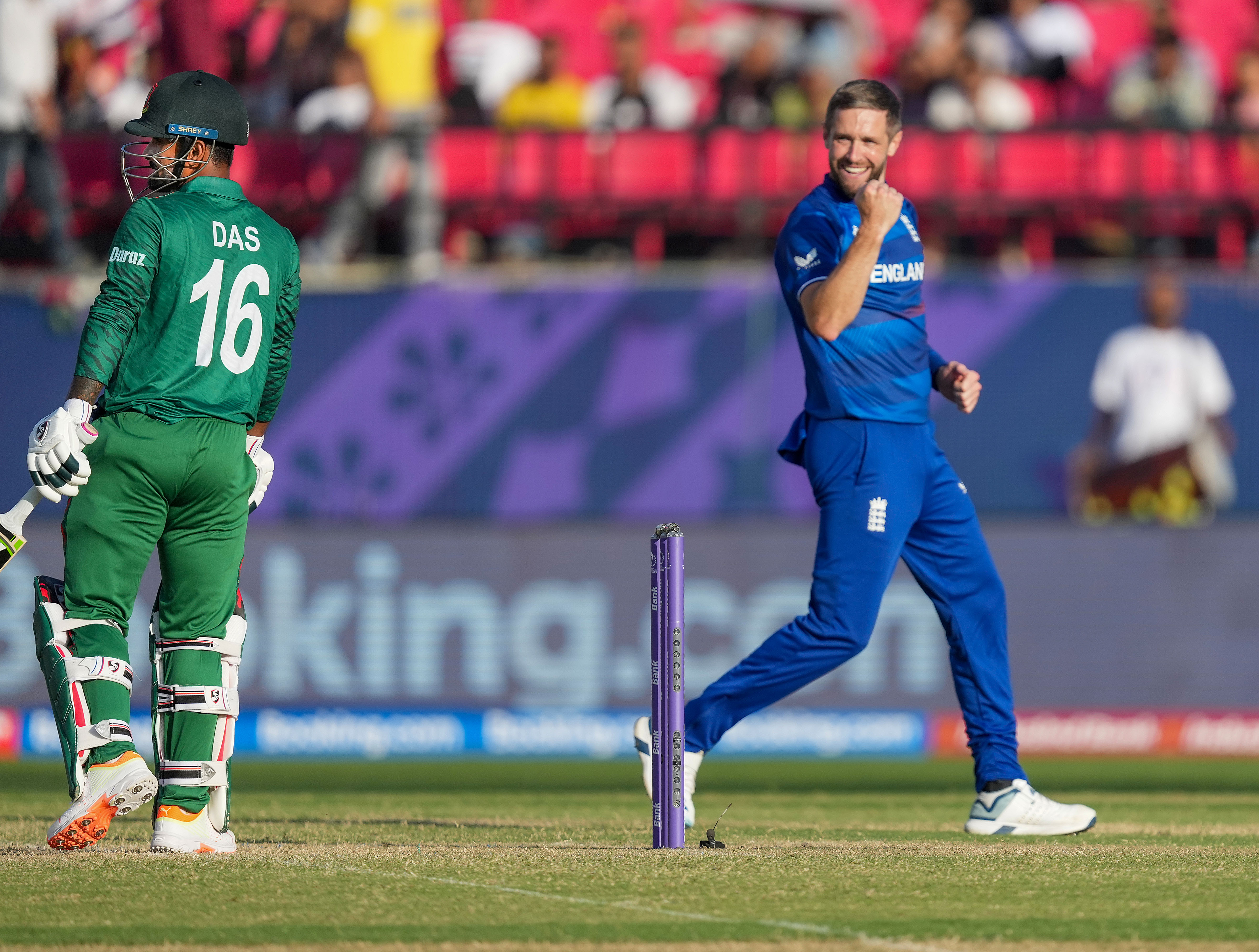 England's Chris Woakes celebrates the wicket of Bangladesh batter Litton Das.