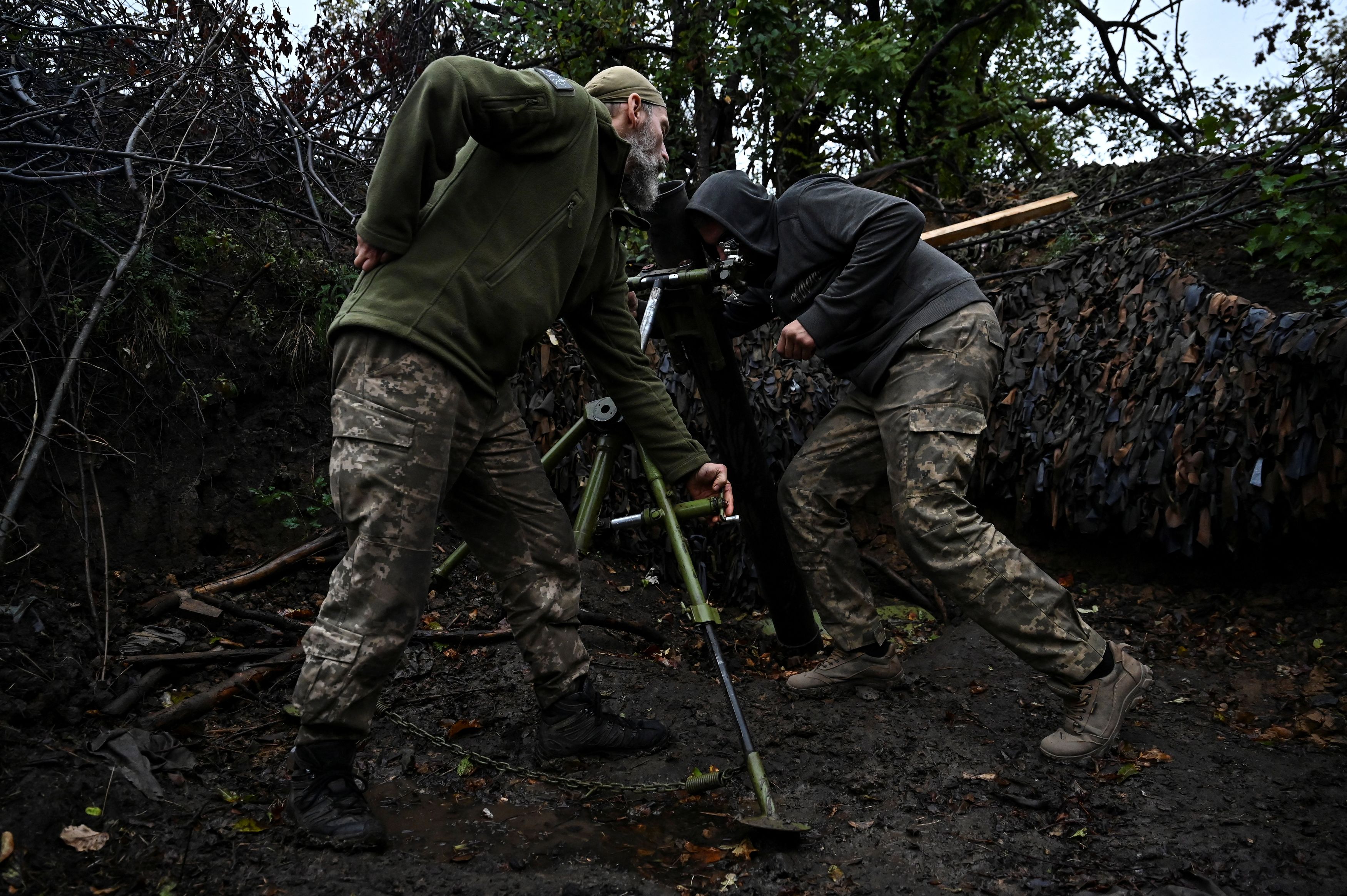 Ukrainian servicemen prepare a mortar to fire toward Russian troops at a position in a front line, amid Russia's attack on Ukraine, at an undisclosed location in Donetsk region, Ukraine October 8, 2023.