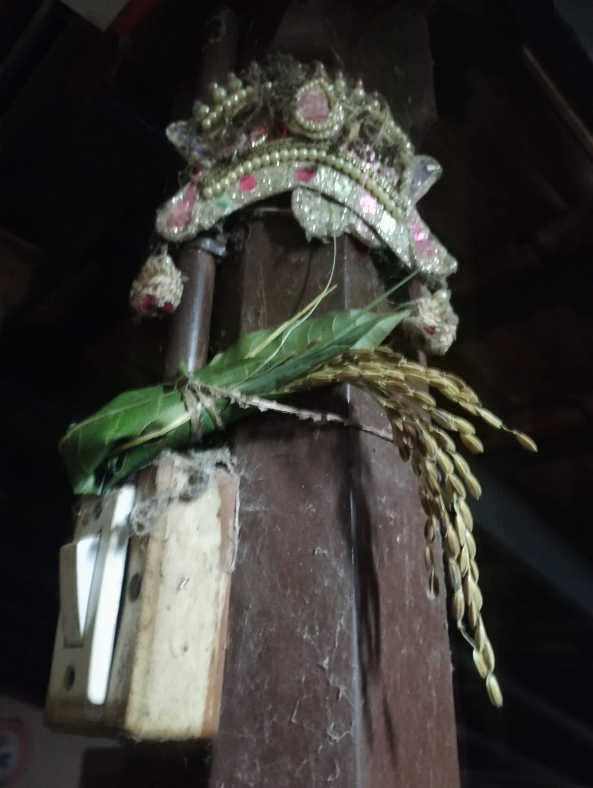 Kadiru tied to a pillar in a home.