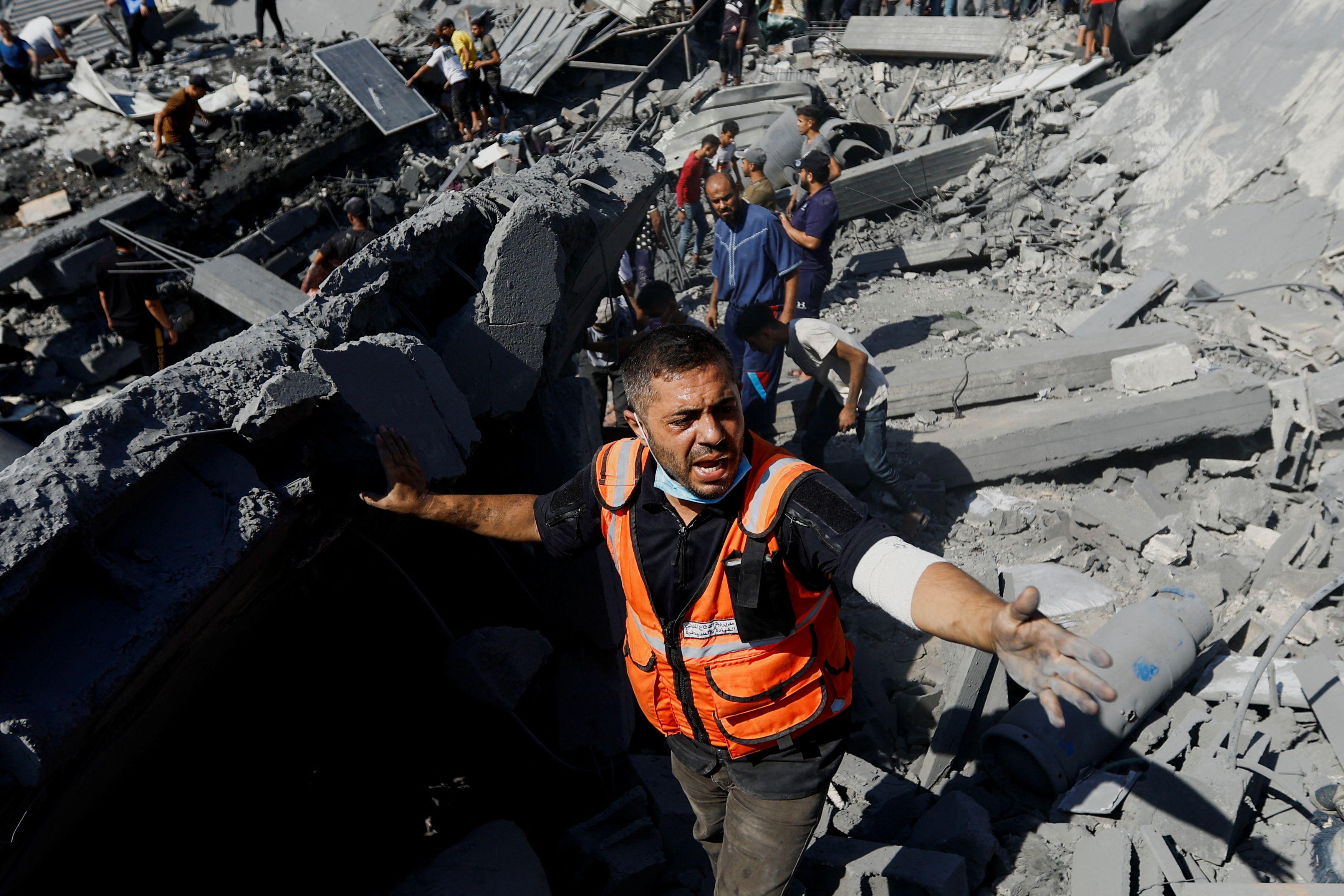 Palestinians search for casualties at the site of Israeli strikes on houses, as the conflict between Israel and Palestinian Islamist group Hamas continues, in Khan Younis in the southern Gaza Strip, October 26, 2023. 