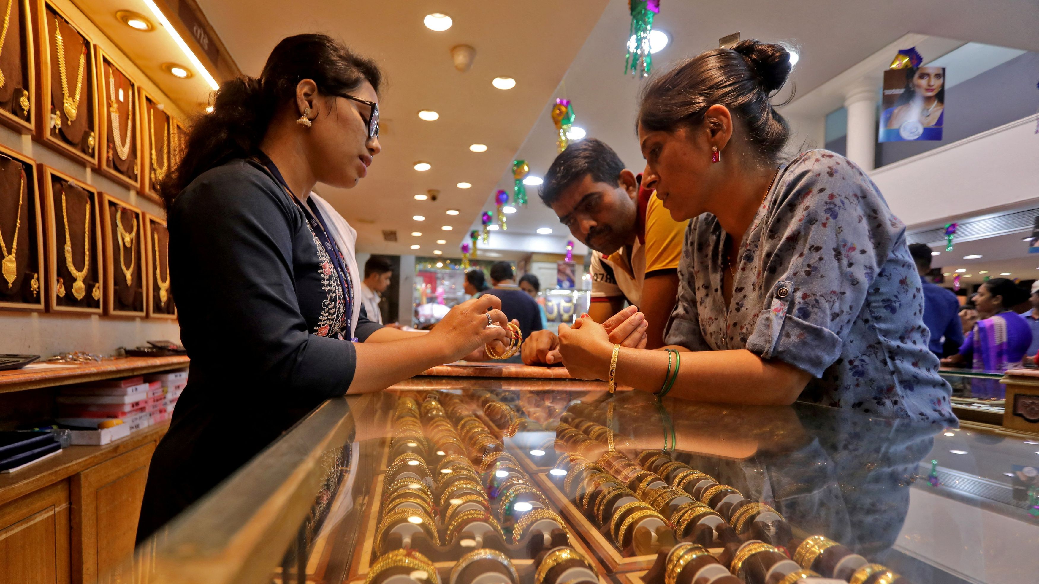 People shop for gold ornaments at a jewellery showroom during Dhanteras, a Hindu festival associated with Lakshmi, the goddess of wealth, in Mumbai, India, October 22, 2022.