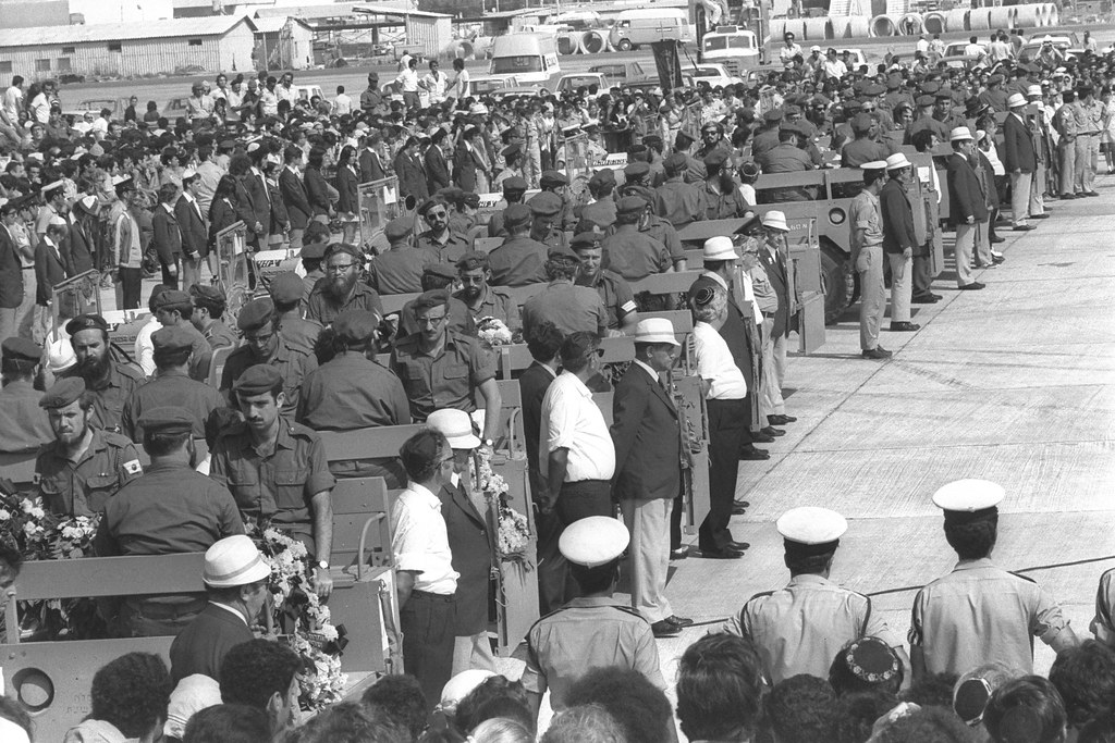 Members of Israeli sports organisations form a Guard of Honor in front of command cars bearing the bodies of victims of the Munich massacre during memorial services at Lod Airport.