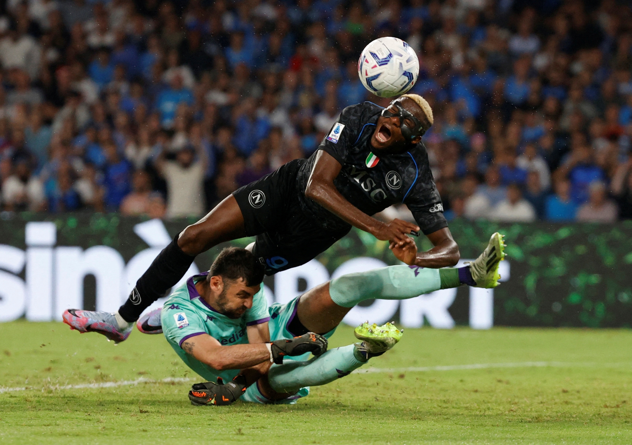 Fiorentina's Pietro Terracciano fouls Napoli's Victor Osimhen to concede a penalty.