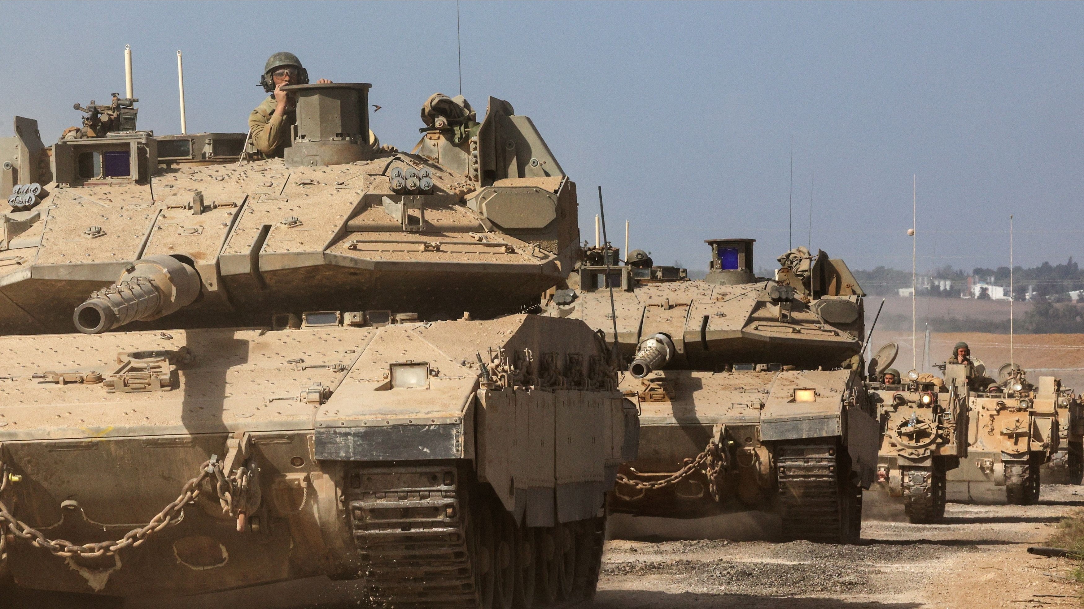 Israeli tanks and military vehicles take position near Israel's border with the Gaza Strip.