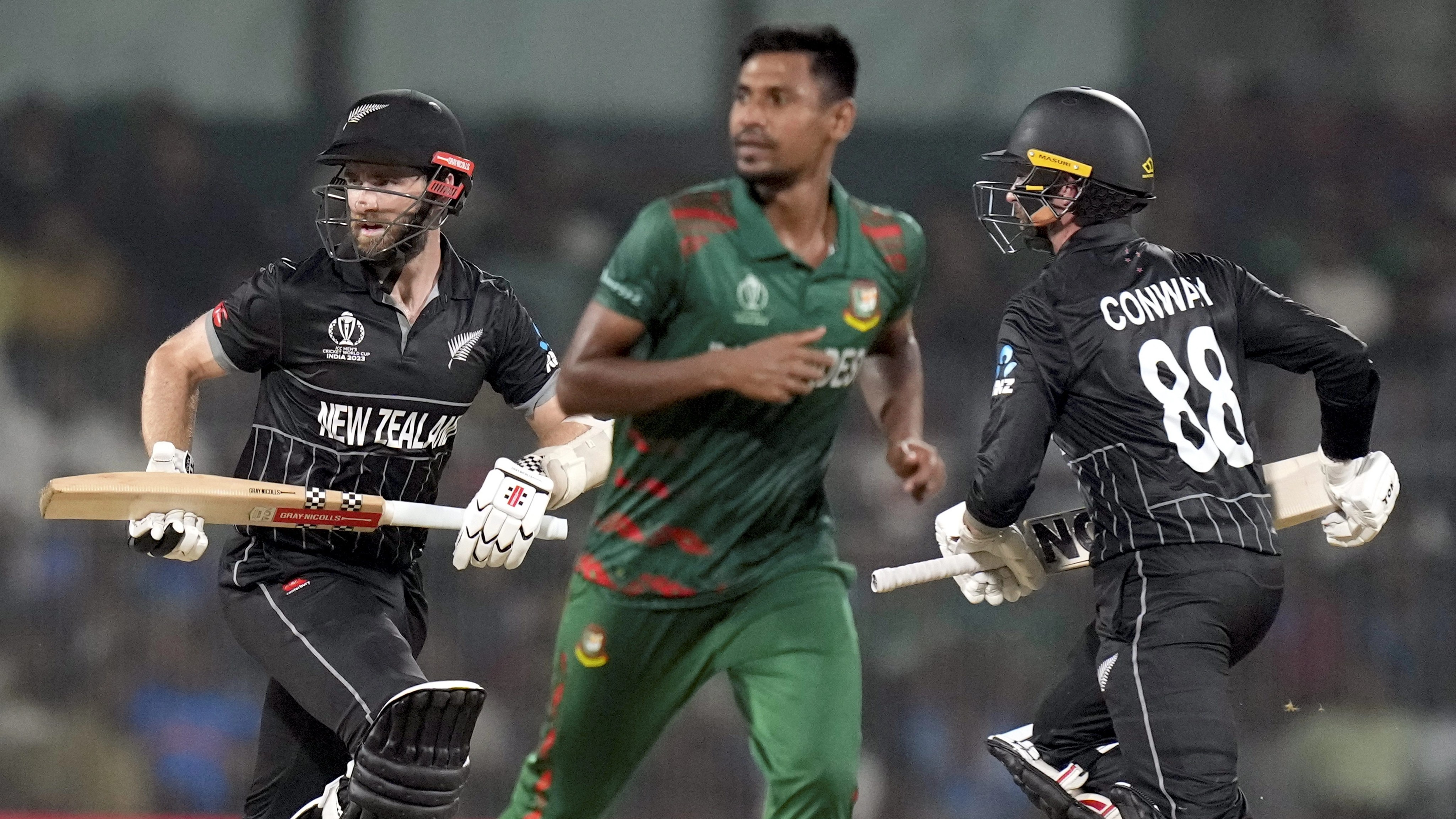 New Zealand' captain Kane Williamson and Devon Conway take runs during the ICC Men's Cricket World Cup 2023 match between New Zealand and Bangladesh, at M.A. Chidambaram Stadium, in Chennai