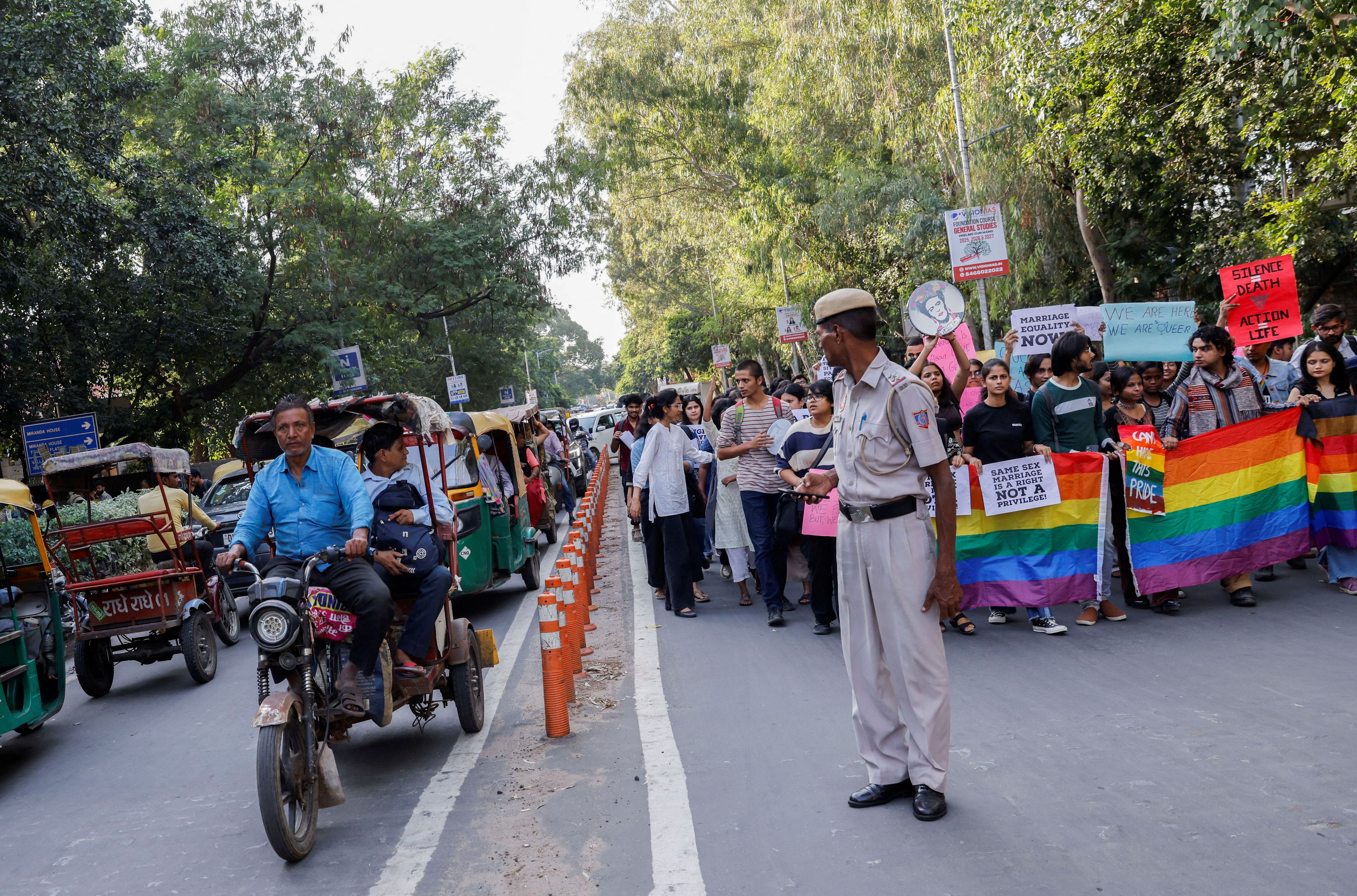 Students and supporters of the Students' Federation of India  shout slogans, hold placards and pride flags as they take part in an LGBT+ Pride vigil organised after India's top court on Tuesday declined to legalise same-sex marriage and left it to parliament to decide, at North Campus in New Delhi, India, October 18, 2023.