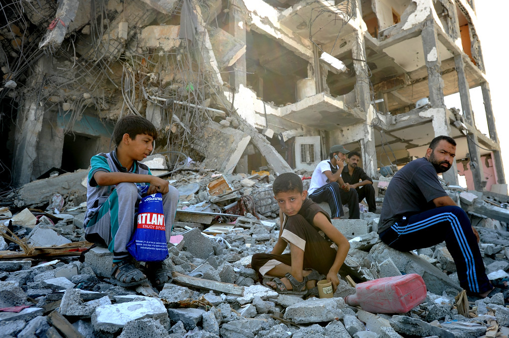Palestinians search through the rubble of their destroyed homes hit by Israeli strikes in the northern Gaza Strip, 2014.