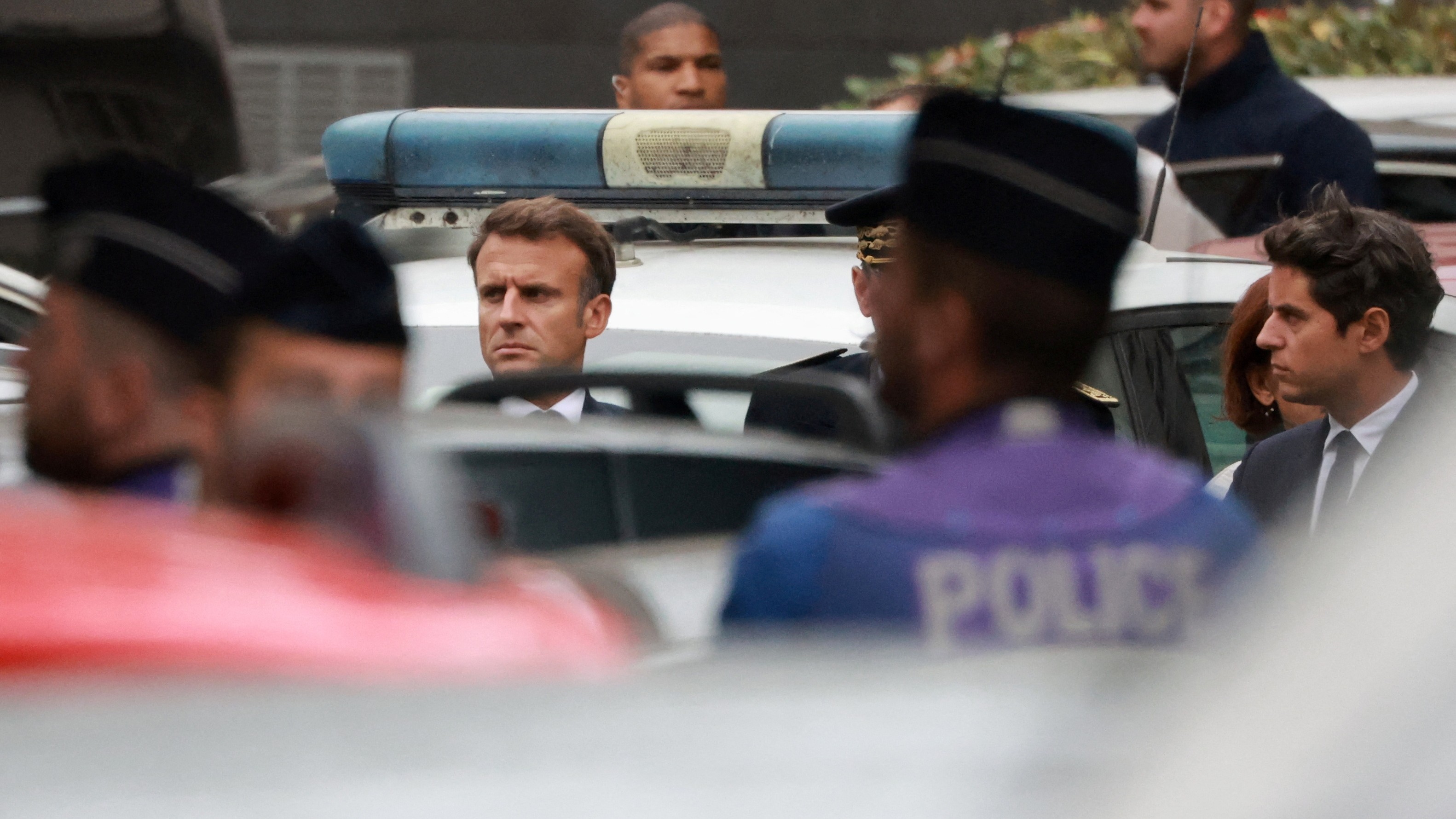 French President Emmanuel Macron and Education and Youth Minister Gabriel Attal arrive at the site after a teacher was killed and several people injured in a knife attack at the Lycee Gambetta-Carnot high school in Arras, northern France.