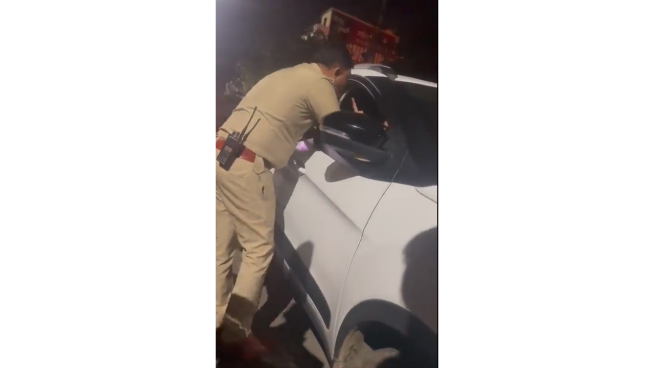 Screengrab of video showing Adam Bidapa interacting with a police office, pointing a finger at the man in uniform.