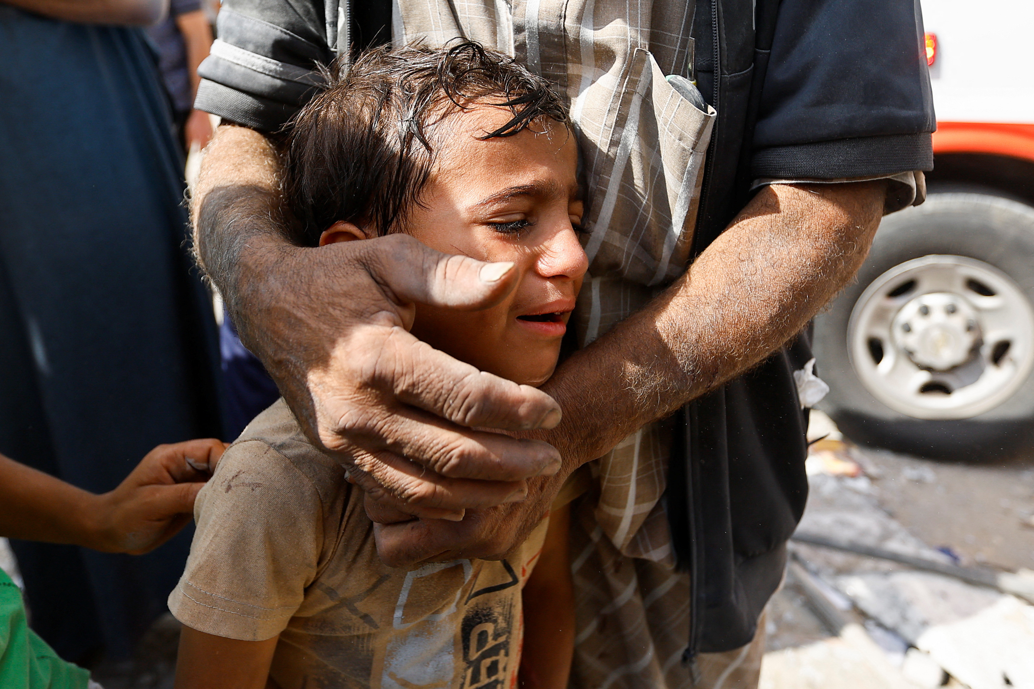 A Palestinian boy reacts, at the site of Israeli strikes on houses, in Rafah in the southern Gaza Strip October 17, 2023. REUTERS/Ibraheem Abu Mustafa